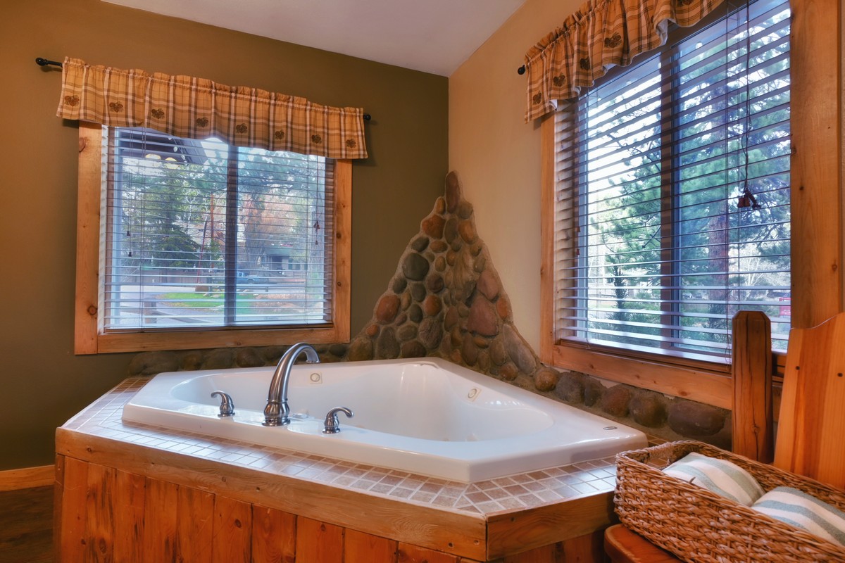 Relaxing indoor jetted tub in the Pine Cone Cabin, a luxury rental at Fall River Cabins.